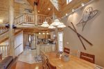 Arrow Lodge- Log stair case and spacious main floor.
